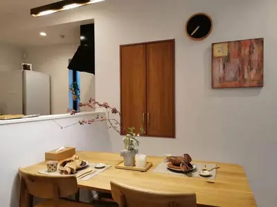 a wooden table in a kitchen with a wooden cabinet at Uhome Ikebukuro Villa 7 in Tokyo