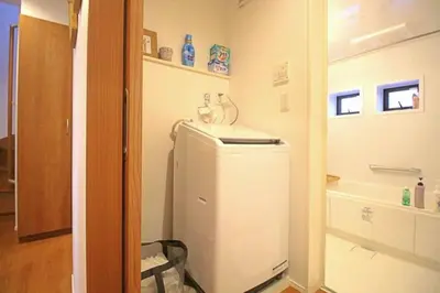 a small refrigerator in a room with a bathroom at Uhome Ikebukuro Villa 7 in Tokyo