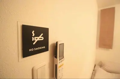 a no smoking sign on the wall of a room at Uhome Ikebukuro Villa 7 in Tokyo
