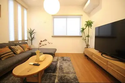 a living room with a couch and a table at Uhome Ikebukuro Villa 7 in Tokyo