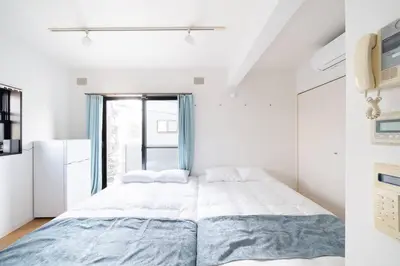 a bedroom with a large bed and a window at Granduo \u677e\u6fe4 in Tokyo