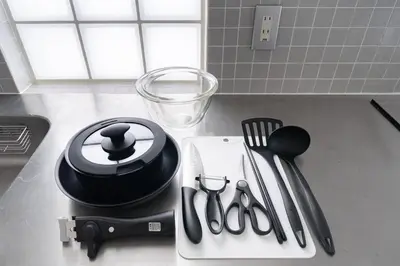a kitchen counter with utensils on a counter top at Granduo \u677e\u6fe4 in Tokyo