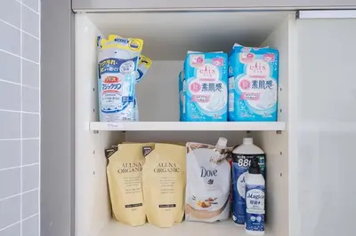 a cabinet filled with lots of bottles of cleaning products at Granduo \u677e\u6fe4 in Tokyo