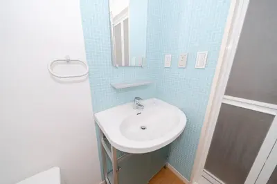 a bathroom with a sink and a mirror at Granduo \u677e\u6fe4 in Tokyo