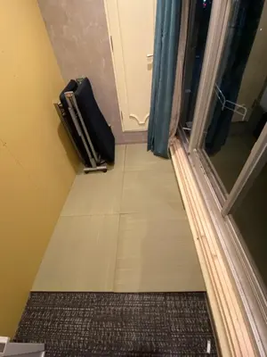 a hallway with a door and a suitcase on the floor at 54Journey Roppongi in Tokyo
