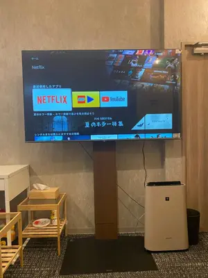 a flat screen tv hanging on a wall at 54Journey Roppongi in Tokyo