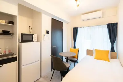 a small room with a bed and a small table at \u58a8\u7530Dias in Tokyo