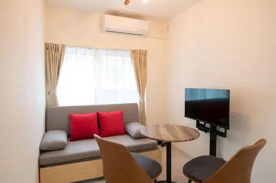 a living room with a couch and a tv at \u58a8\u7530Dias in Tokyo