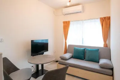 a living room with a couch and a tv and a table at \u58a8\u7530Dias in Tokyo