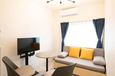 a living room with a couch and a tv at \u58a8\u7530Dias in Tokyo