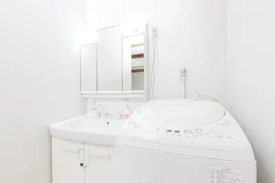 a white bathroom with a sink and a mirror at Sola Stay Kanegafuchi in Tokyo