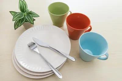 a table with plates and cups and utensils at Sola Stay Kanegafuchi in Tokyo