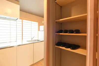 a kitchen with white cabinets and a sink at Asagaya House by Tranova in Tokyo