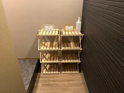 a room with three shelves with bottles on them at Asagaya House by Tranova in Tokyo