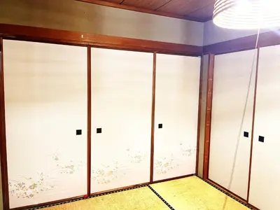a room with sliding glass doors with flowers on the wall at Tatami room & Living Room equipped with Multinational TV and Fire, BBQ corner in Tokyo Downtown House in Tokyo