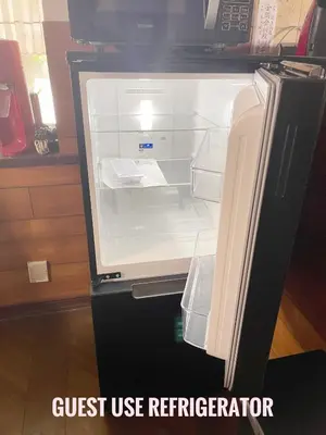 an empty refrigerator with its door open in a kitchen at Tatami room & Living Room equipped with Multinational TV and Fire, BBQ corner in Tokyo Downtown House in Tokyo