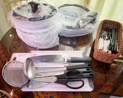 a pair of scissors sitting on top of a table at Tatami room & Living Room equipped with Multinational TV and Fire, BBQ corner in Tokyo Downtown House in Tokyo