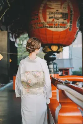 a woman standing in front of a table with a lantern at 203 Oshiage sta 3mins walk! Wi-Fi Elevator 4pax in Tokyo