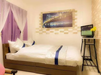 a bedroom with a bed and a laptop on a desk at 203 Oshiage sta 3mins walk! Wi-Fi Elevator 4pax in Tokyo