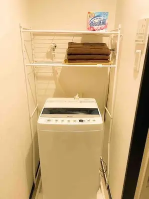 a small kitchen with a white stove and towels at 203 Oshiage sta 3mins walk! Wi-Fi Elevator 4pax in Tokyo