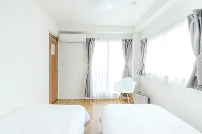 a bedroom with two beds and a window at 駒込駅徒歩7分/旧古河庭園至近(100m)の4LDKマンション「92m2」 in Tokyo