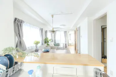 a living room with white walls and a wooden table at 駒込駅徒歩7分/旧古河庭園至近(100m)の4LDKマンション「92m2」 in Tokyo