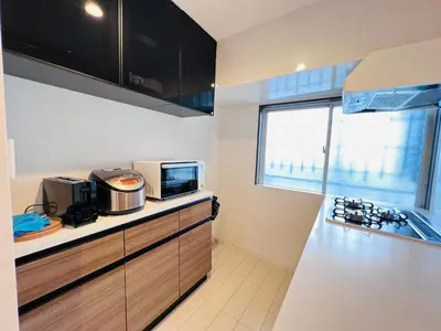a kitchen with a counter top with a microwave at shinjuku Jun7F-SJ0095 in Tokyo