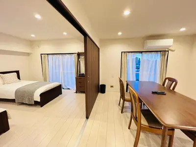 a hotel room with a bed and a dining table and a bedroom at shinjuku Jun7F-SJ0095 in Tokyo