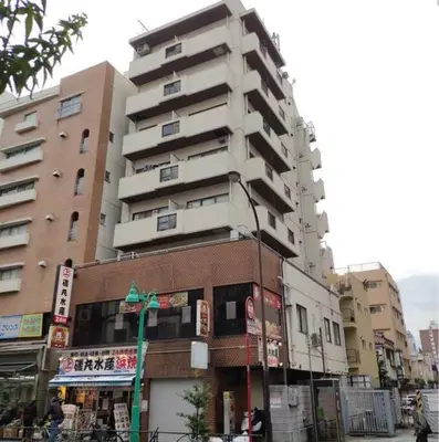 a tall apartment building on a city street at \u7834\u68c4\u30ea\u30b9\u30c6\u30a3\u30f3\u30b0 in Tokyo