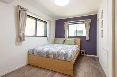 a bedroom with a bed and two windows at Ici Japon Village in Tokyo