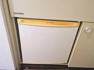 a white refrigerator with its door open in a room at DP House in Tokyo