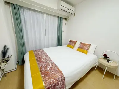 a bedroom with a white bed and a window at Shinjuku HM hotel-SJ0016 in Tokyo