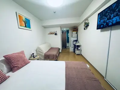 a bedroom with a white bed and a couch at Shinjuku HM hotel-SJ0016 in Tokyo