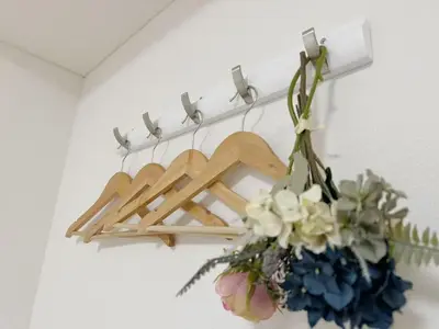 a bunch of wooden hangers on a wall with flowers at Shinjuku HM hotel-SJ0016 in Tokyo