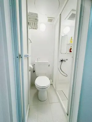 a small bathroom with a toilet and a shower at Shinjuku HM hotel-SJ0016 in Tokyo