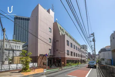 a building on the side of a city street at Hotel Residence Ohashi Kaikan Tokyo Shibuya in Tokyo