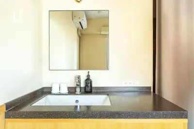 a bathroom with a sink and a mirror at Hotel Residence Ohashi Kaikan Tokyo Shibuya in Tokyo