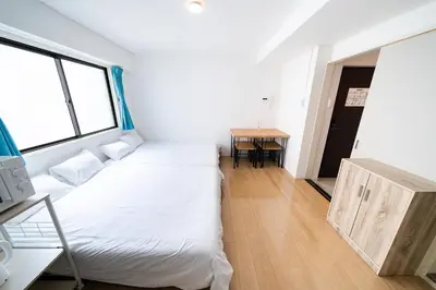 a small room with a bed and a table at SUA HOTEL Nishikasai in Tokyo