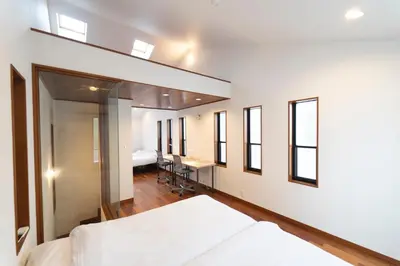 a bedroom with a bed and a desk and windows at Minato-ku - House - Vacation STAY 14528 in Tokyo