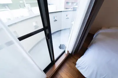 a room with a glass door and a bed at Minato-ku - House - Vacation STAY 14528 in Tokyo
