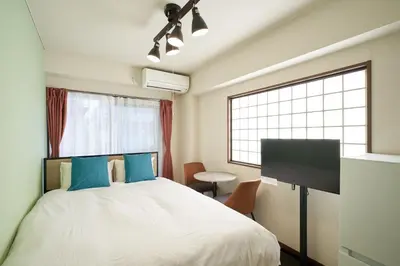 a bedroom with a bed and a large window at \u30ac\u30fc\u30c7\u30f3\u5927\u585a in Tokyo