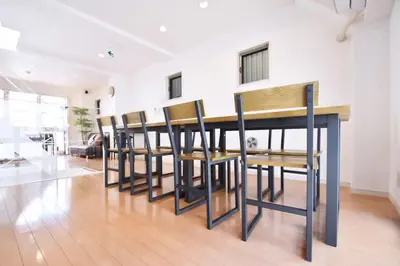 a room with a row of tables and chairs at TERRACE HOUSE Shibuya Maruyamacho - Vacation STAY 79338v in Tokyo