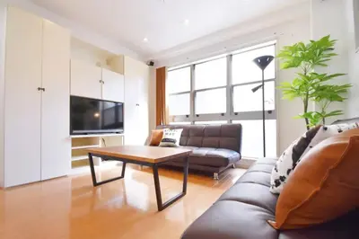 a living room with a couch and a coffee table at TERRACE HOUSE Shibuya Maruyamacho - Vacation STAY 79338v in Tokyo