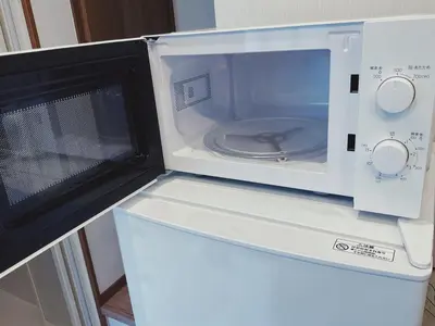 a microwave sitting on top of a refrigerator at KUMOMA - Vacation STAY 92923v in Tokyo