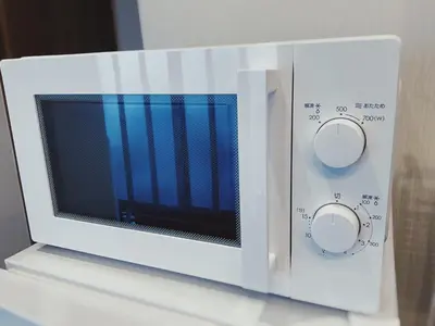 a white microwave oven sitting on top of a counter at KUMOMA - Vacation STAY 92923v in Tokyo