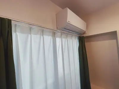 a room with a curtain and a air conditioner above a window at KUMOMA - Vacation STAY 92923v in Tokyo