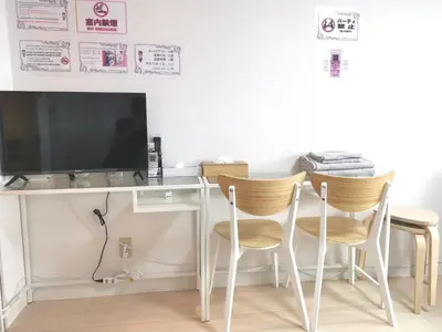 a room with two chairs and a desk with a television at Lions Mansion Kabukicho No2 with2 bedroom in Tokyo