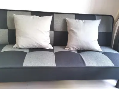 a couch with two pillows on it at Lions Mansion Kabukicho No2 with2 bedroom in Tokyo