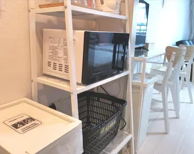 a tv sitting on top of a shelf next to a table at Lions Mansion Kabukicho No2 with2 bedroom in Tokyo
