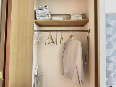 a closet with a white shirt and hangers at K Shinjuku area-MAX 4p-\u65b0\u5bbf\u4e2d\u5fc3\u5730\u57df-\u6b65\u884c\u53ef\u5230\u65b0\u5bbf\u5927\u4e45\u4fdd\u6b4c\u821e\u4f0e\u753a-\u53ef\u4f4f4\u4eba in Tokyo